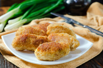 Chicken patties or fish cakes fried in breadcrumbs
