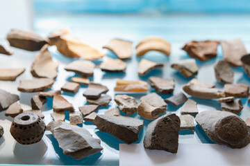 Clay shards or fragments old retro vintage antique medieval archaeological finds. Background with...