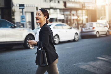 Obraz premium Off to meet a client around town. Shot of a young businesswoman walking in the city.