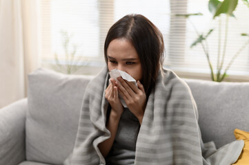 Daily life or health problem concept : Young Asian woman caught a cold and have a running nose or fever have to rest at her home and absent from her job.