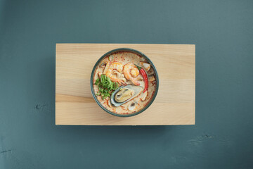 Tom Yum Kung Soup, top view, copy space. Traditional thai asian tom yam soup.