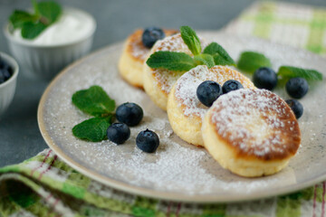 Plate with tasty cottage cheese pancakes and berries on table