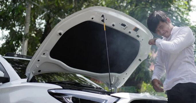 Portrait side view of Man open the hood and looking at car smoke engine. Car service concept.