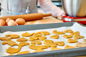 Cookies in shape of heart on oven paper. Homemade pastries or cake. Baking cookies.