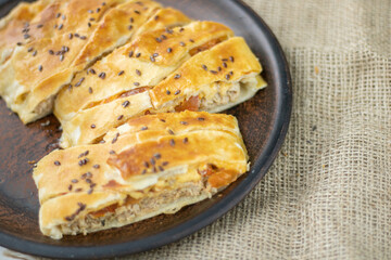 meat pie with tomatoes and puff pastry cheese