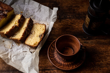 Tea party and banana bread. A cup of herbal tea. Banana bread sliced. Dark wooden background.