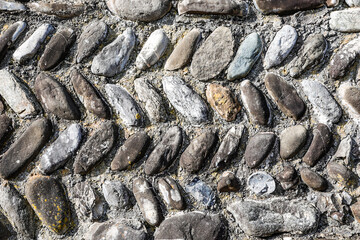 Pattern of evenly laid old natural stones as background