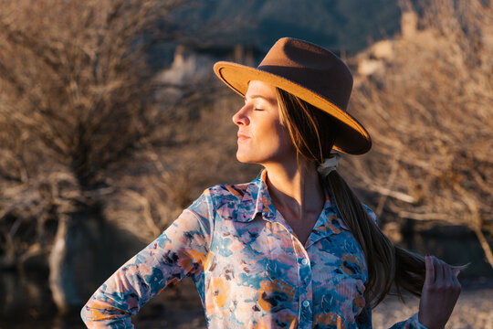 Woman in ht standing in countryside