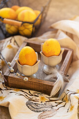 Dyed Easter eggs with marble stone effect painted with natural dye by turmeric on old background