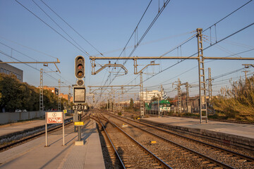 Fototapeta premium Barcelona, Spain - December 20, 2021. Train tracks and power pylons at a Spanish train station near Barcelona. rails and sleepers close up.