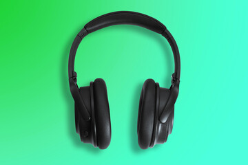 Computer headphones. Black headphones on a white background. The concept of listening to music, creating audio, music. Computer work, abstraction and minimalist style.