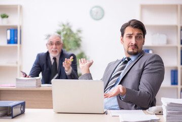 Two male employees working in the office