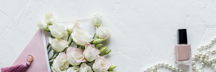 Beauty blog concept. Accessories, flowers, cosmetics and jewelry on white background. Womens Day concept.Woman fashion accessories, Eustoma, cosmetics and jewelry on pink background, copyspace.