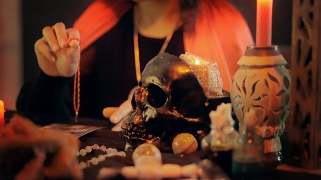 Soothsayer with ring looking for person by photo, candle light, enchantment