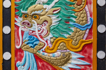 Close up of a colorful wall decoration with Chinese dragon in the ancient monastery of Gyegu, Qinghai province, China
