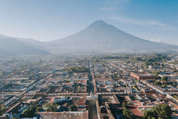 Antigua Guatemala, classic colonial city with the famous Santa Catalina Arch and Volcano of Water behind - Antigua Guatemala aerial photography