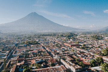 Antigua Guatemala, classic colonial city with the famous Santa Catalina Arch and volcano of Water behind - Antigua Guatemala aerial photography - Central America, Guatemala