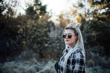 young woman with youth hairstyle white dreadlocks pigtails, concept of modern young women.