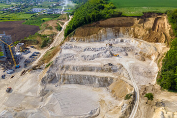 Open pit mining of construction sand stone materials with excavators and dump trucks