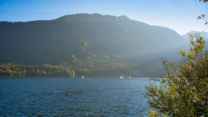 Sailboats on fantastic Bohinj lake in Triglav national park in Slovenia: mountains, pure water and reflection