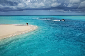 Boat going through the channel between Mouli and Ouvea Islands, Loyalty Islands, New Caledonia.