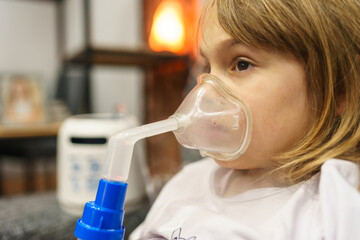 Shot of a sad girl sitting on a couch and taking his respiratory therapy.
