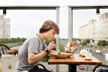 Lifestyle portrait of a young man using a smart phone outdoors