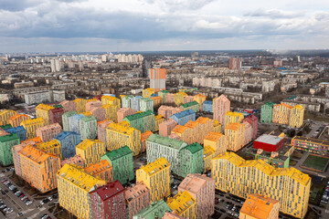 Many multi-colored residential buildings in Kiev in cloudy weather. Aerial drone view.