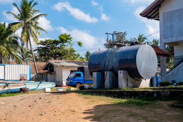 water tank in tropical country with a car