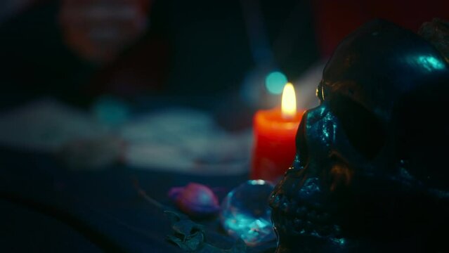 Black skull in dark room, witch conducting satanic rituals, psychic powers