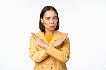 Stop gesture. Serious asian woman making arm cross, prohibit smth, rejecting, dislike and...