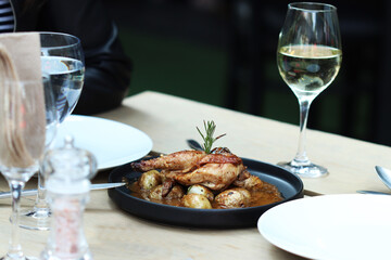 Roasted Chicken on black plate and wood table