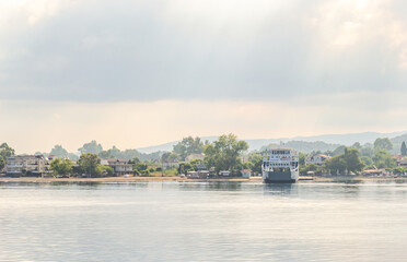 Naklejka premium Evia island, Greece - June 30. 2020: Anchored ferry in the port of Edipsos - Greece.
