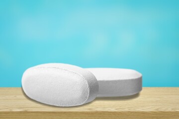 COVID-19 experimental antiviral drug, two white pills on a background