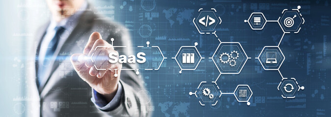 SaaS Software as a Service concept with man hand pressing text