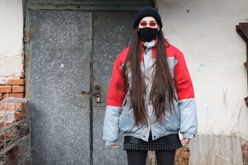 portrait of a girl wearing red glasses and black mask