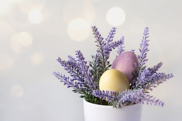 beautiful Easter card with colored eggs in purple flower