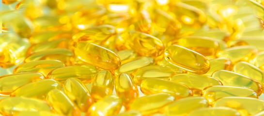Omega 3 supplement many fish oil capsules. Selective focus.
