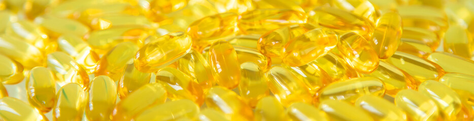 Omega 3 supplement many fish oil capsules. Selective focus.