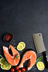 Raw organic salmon steak with ingredients for making : lemon, spices and vegetables. Top view with copy space.