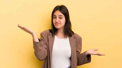 young hispanic woman looking puzzled, confused and stressed, wondering between different options,...