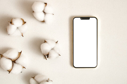 Mobile phone mockup with cotton leaves on the white background
