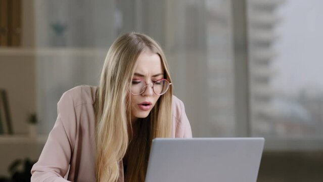 Scocked caucasian millennial business woman female student worker user receiving bad news message low grade test failed exams losing computer bet feeling shock lost fear horror looking at laptop