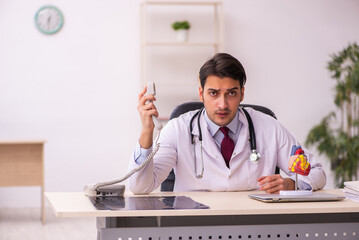 Young male doctor cardiologist working in the clinic