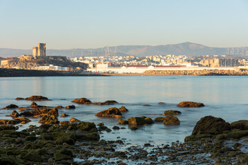 Long exposure view of the coastal town of Tarifa from the rocky beach of the Island of Tarifa at sunset, Cadiz, Andalusia, Spain