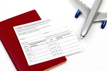 Obraz premium COVID-19 vaccination record card and tourist passport of traveler for worldwide travel during coronavirus pandemic. - Image