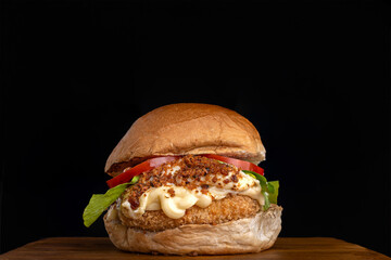 Homemade hamburger with cream cheese, bacon farofa, lettuce and tomato