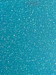 close up of aqua plastic board with crumbs pattern