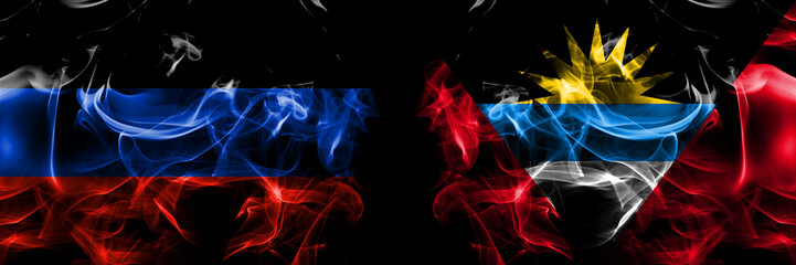 Donetsk People's Republic vs Antigua and Barbuda, Antiguan and Barbudan flag. Smoke flags placed side by side isolated on black background.