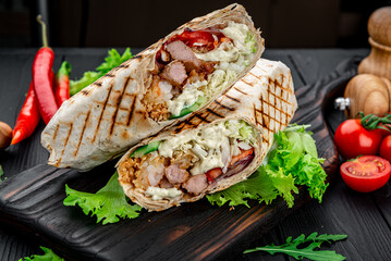 Burrito with grilled beef and vegetables. Shawarma